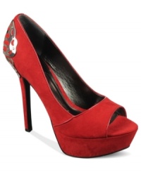A metal butterfly decal adorns the back of the Sexy Too platform pumps by Carlos by Carlos Santana, creating a look that's truly transformative. A metal butterfly decal adorns the back of the Sexy Too platform pumps by Carlos by Carlos Santana, creating a look that's truly transformative.