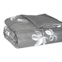 Large floral blossoms in watercolor shades of white and grey dance across a dark grey background on duvets and shams in this collection by Vera Wang. Reverse is a suiting pinstripe. Large floral blossoms in watercolor shades of white and grey dance across a dark grey background on duvets and shams in this collection by Vera Wang. Reverse is a suiting pinstripe.