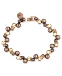 Wrist watching will be the order of the day with this flex bracelet from Givenchy. Crafted from brown gold-tone mixed metal with glass pearls, all eyes will be drawn to this stylish piece. Approximate length: 7-1/4 inches. Wrist watching will be the order of the day with this flex bracelet from Givenchy. Crafted from brown gold-tone mixed metal with glass pearls, all eyes will be drawn to this stylish piece. Approximate length: 7-1/4 inches.