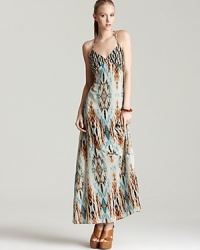 Flourished with an exotic print, this GUESS maxi dress is casual enough for daytime shopping and striking enough for seaside cocktais. Flourished with an exotic print, this GUESS maxi dress is casual enough for daytime shopping and striking enough for seaside cocktais.