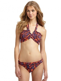 THE LOOKSpirited abstract animal and floral printAdjustable halter straps tie at neckBands crisscross at center with V-shaped openingPadded cups and side boningBack clasp closureTHE MATERIAL80% nylon/20% spandexFully linedCARE & ORIGINHand washImportedPlease note: Bikini bottom sold separately. THE LOOKSpirited abstract animal and floral printAdjustable halter straps tie at neckBands crisscross at center with V-shaped openingPadded cups and side boningBack clasp closureTHE MATERIAL80% nylon/20% spandexFully linedCARE & ORIGINHand washImportedPlease note: Bikini bottom sold separately.