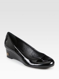 A polished classic wedge of smooth patent leather, finished with a petite goldtone designer emblem. Wedge heel, 1½ (40mm)Patent leather upperLeather lining and solePadded insoleImportedOUR FIT MODEL RECOMMENDS ordering true size. A polished classic wedge of smooth patent leather, finished with a petite goldtone designer emblem. Wedge heel, 1½ (40mm)Patent leather upperLeather lining and solePadded insoleImportedOUR FIT MODEL RECOMMENDS ordering true size.