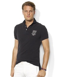 Cut in trimmer proportions for modern, more athletic look, an essential short-sleeved polo shirt is rendered in breathable cotton mesh with heritage embroidery. Cut in trimmer proportions for modern, more athletic look, an essential short-sleeved polo shirt is rendered in breathable cotton mesh with heritage embroidery.