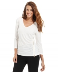 Calvin Klein adds urban appeal to this V-neck top with a shiny gold zipper at the side. Calvin Klein adds urban appeal to this V-neck top with a shiny gold zipper at the side.