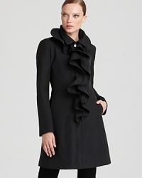 A flirty spray of cascading ruffles enliven this modern Elie Tahari trench coat with an extra feminine touch. A flirty spray of cascading ruffles enliven this modern Elie Tahari trench coat with an extra feminine touch.