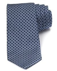 This plush silk tie balances a whimsical pattern of dots and circles with a traditional 3.5 width for a refined style that's perfect for the office or any of your dressed-up affairs. This plush silk tie balances a whimsical pattern of dots and circles with a traditional 3.5 width for a refined style that's perfect for the office or any of your dressed-up affairs.