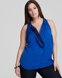 An electric palette ignites a ruffled Tahari Woman Plus blouse for an impact look. Showcase the vibrant silhouette against sleek, black denim. An electric palette ignites a ruffled Tahari Woman Plus blouse for an impact look. Showcase the vibrant silhouette against sleek, black denim.