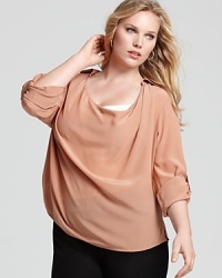 This flowing Eileen Fisher draped silk shirt lets you choose the length of your sleeves with an adjustable buttoned roll tab. Team the silk piece with staple black pants for an instant infusion of effortless chic. This flowing Eileen Fisher draped silk shirt lets you choose the length of your sleeves with an adjustable buttoned roll tab. Team the silk piece with staple black pants for an instant infusion of effortless chic.