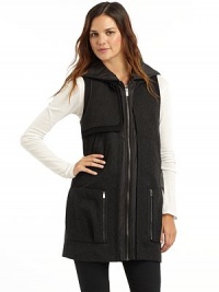 THE LOOKQuilted hoodWool blend stand collarSleevelessSingle gun flapZip frontDual welt & zip pocketsTonal pipingBack button tab detailTHE FITAbout 30½ from shoulder to hemTHE MATERIAL43% wool/30% rayon/27% polyesterTrim & fill: polyesterFully linedCARE & ORIGINDry cleanImported