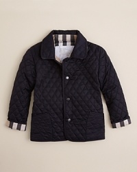 Burberry taps into a traditional look with a refined version of the hunting jacket, rendered in a solid quilted fabric and check trim. Burberry taps into a traditional look with a refined version of the hunting jacket, rendered in a solid quilted fabric and check trim.