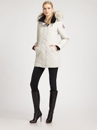 Natural coyote-fur trims the drawstring hood of this parka. Natural coyote-fur trims the drawstring hood of this parka.