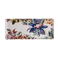An opulent blue flower blooms from a backdrop of garden delights on the fresh, fun Eden oblong tray from Gien France. An opulent blue flower blooms from a backdrop of garden delights on the fresh, fun Eden oblong tray from Gien France.