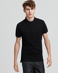 A stripe trim at the collar adds a hint of graphic appeal to the Burberry Adler polo. A stripe trim at the collar adds a hint of graphic appeal to the Burberry Adler polo.
