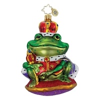 A royal frog presides over his glittering pad with a red and gold robe, crown and scepter. A royal frog presides over his glittering pad with a red and gold robe, crown and scepter.