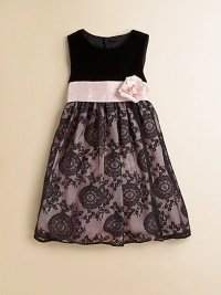 An elegant frock crafted in a sleeveless silhouette with a velvet bodice, floral detail and delicate lace skirt.Round necklineSleevelessBack buttonsWaistband with sash and flowerFull skirtPolyester tulleDry cleanImported of domestic fabric Please note: Number of buttons may vary depending on size ordered. An elegant frock crafted in a sleeveless silhouette with a velvet bodice, floral detail and delicate lace skirt.Round necklineSleevelessBack buttonsWaistband with sash and flowerFull skirtPolyester tulleDry cleanImported of domestic fabric Please note: Number of buttons may vary depending on size ordered.