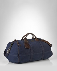 Ideal for travel, a rugged canvas duffle gets a luxe update from rich leather handles.Full-zip top closure. Ideal for travel, a rugged canvas duffle gets a luxe update from rich leather handles.Full-zip top closure.