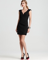 An asymmetrical peplum adds interest to this Black Halo dress--a chic, modern twist on the classic LBD. An asymmetrical peplum adds interest to this Black Halo dress--a chic, modern twist on the classic LBD.