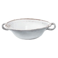 This Vietri serving bowl was crafted by hand in Tuscany of durable, textural terra cotta for an irresistibly warm appeal. Ornament rolls are used to create its ornate designs.