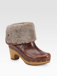 An ultra-soft shearling cuff tops this studded design of rich leather, lifted by a wooden heel. Wooden heel, 3 (75mm)Wooden platform, 1 (25mm)Compares to a 2 heel (50mm)Leather and shearling upperPull-on styleShearling liningRubber solePadded insoleImported An ultra-soft shearling cuff tops this studded design of rich leather, lifted by a wooden heel. Wooden heel, 3 (75mm)Wooden platform, 1 (25mm)Compares to a 2 heel (50mm)Leather and shearling upperPull-on styleShearling liningRubber solePadded insoleImported