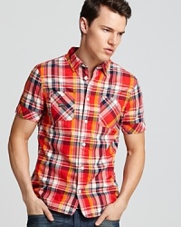 A bright button-down sport shirt with a slim fitting silhouette and double chest pockets gives your casual cool look a jolt of color. A bright button-down sport shirt with a slim fitting silhouette and double chest pockets gives your casual cool look a jolt of color.