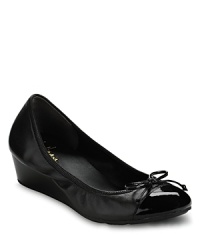 A sweet, slim bow trims these captoe wedges, the perfect marriage of comfort and chic. By Cole Haan. A sweet, slim bow trims these captoe wedges, the perfect marriage of comfort and chic. By Cole Haan.