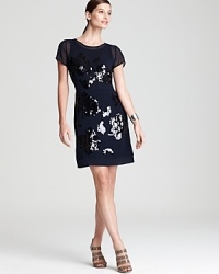 Fashion's greatest hit, the DKNY black dress, gets a modern remix with sheer detailing and a splash of sparkles. Finish with strappy sandals and start moving to the style beat. Fashion's greatest hit, the DKNY black dress, gets a modern remix with sheer detailing and a splash of sparkles. Finish with strappy sandals and start moving to the style beat.