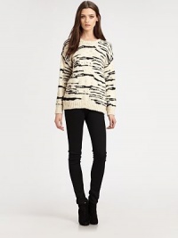 Contrasting, abstract stripes and a slouchy fit reinvent this merino wool sweater with ribbed trim. Ribbed roundneckDropped shouldersLong sleevesRibbed cuffs and hemLonger length hits below the hipsMerino woolDry cleanImportedModel shown is 5'10 (177cm) wearing US size Medium.
