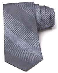 An allover tonal plaid pattern with a narrower shape elevates the cool factor on your hip and polished look. An allover tonal plaid pattern with a narrower shape elevates the cool factor on your hip and polished look.