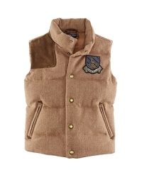 The essential down vest gets a tailored update in a preppy herringbone tweed with a suede shoulder patch for a heritage look. The essential down vest gets a tailored update in a preppy herringbone tweed with a suede shoulder patch for a heritage look.