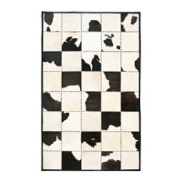 The bold black and white cowhide patchwork motif on this Ralph Lauren rug warms your living space with a sleek interpretation of Western style. The bold black and white cowhide patchwork motif on this Ralph Lauren rug warms your living space with a sleek interpretation of Western style.
