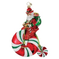 Old Saint Nick rides a candy-themed unicycle to deliver Christmas presents in this boldly bright ornament.