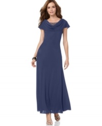 The draped neckline of this petite evening gown by Patra reveals a layer of sheer fabric beneath, embellished with sparkling beading. The draped neckline of this petite evening gown by Patra reveals a layer of sheer fabric beneath, embellished with sparkling beading.