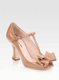 Patent leather style with an adjustable t-strap, oversized bow adornment and a modern, sculpted heel. Self-covered heel, 3 (75mm)Patent leather upperLeather lining and solePadded insoleMade in ItalyOUR FIT MODEL RECOMMENDS ordering one half size up as this style runs small. Patent leather style with an adjustable t-strap, oversized bow adornment and a modern, sculpted heel. Self-covered heel, 3 (75mm)Patent leather upperLeather lining and solePadded insoleMade in ItalyOUR FIT MODEL RECOMMENDS ordering one half size up as this style runs small.