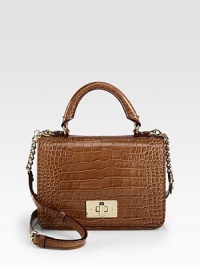 A chic boxy frame in luxurious patent crocodile embossed leather.Top handle, 4½ dropDetachable adjustable chain and patent crocodile embossed leather shoulder strap, 20-22½ dropTurnlock flap closureOne inside zip pocketTwo inside open pocketsFully lined9½W X 7H X 3½DImported