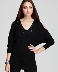 A splash of sequins emblazon a cold-shoulder DKNY sweater, taking the everyday staple to statement status. A splash of sequins emblazon a cold-shoulder DKNY sweater, taking the everyday staple to statement status.