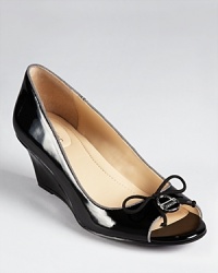 Little locks decorate the toe of Calvin Klein's Olita pumps, glossy in patent leather and ideal for all-day wear with a modest heel. Little locks decorate the toe of Calvin Klein's Olita pumps, glossy in patent leather and ideal for all-day wear with a modest heel.