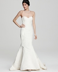 Opt for understated glamour in this Nicole Miller mermaid gown of sweeping silk. Opt for understated glamour in this Nicole Miller mermaid gown of sweeping silk.