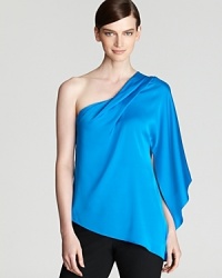 Fluid silks cascades the length of a one-shoulder Elie Tahari blouse for a striking feminine silhouette. Fluid silks cascades the length of a one-shoulder Elie Tahari blouse for a striking feminine silhouette.