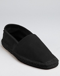 Salvatore Ferragamo bring its signature sophistication to your leisure look. This comfy slip on is crafted in soft cotton, with leather trim and espadrille along the sides and toe.