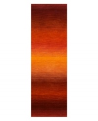 Imparting warm visions of brilliant sunrises on the horizon, this deeply textured rug features intense tones of red and orange that recall a perfect morning sky. Hand-tufted and color blended with the greatest of care, this wool rug comes alive with texture and color. Imparting warm visions of brilliant sunrises on the horizon, this deeply textured rug features intense tones of red and orange that recall a perfect morning sky. Hand-tufted and color blended with the greatest of care, this wool rug comes alive with texture and color.