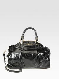 A roomy carryall in glossy leather embellished with large bows.Double top handles, 4½ dropDetachable shoulder strap, 18 dropTop zip closureProtective metal feetOne inside zip pocketOne inside open pocketSatin lining12¾W X 9¾H X 6DMade in Italy A roomy carryall in glossy leather embellished with large bows.Double top handles, 4½ dropDetachable shoulder strap, 18 dropTop zip closureProtective metal feetOne inside zip pocketOne inside open pocketSatin lining12¾W X 9¾H X 6DMade in Italy