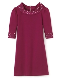 Vintage-chic gets the royal treatment with this berry hued Nicole Miller dress featuring sparkling rhinestones at the neck and cuffs. Vintage-chic gets the royal treatment with this berry hued Nicole Miller dress featuring sparkling rhinestones at the neck and cuffs.