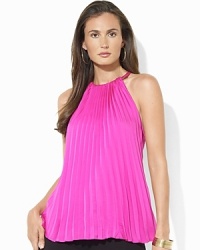 A halter neckline and a pleated front add elements of flirty femininity to a sleek silk halter top. A halter neckline and a pleated front add elements of flirty femininity to a sleek silk halter top.