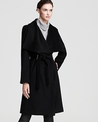 This Calvin Klein coat features a grand cascade collar and a fetching belted waist for refined elegance when temperatures fall. This Calvin Klein coat features a grand cascade collar and a fetching belted waist for refined elegance when temperatures fall.