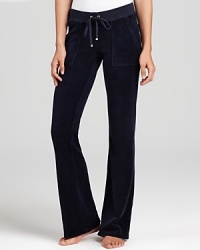 Snap-patch back pockets lend a utility-inspired feel to Juicy Couture's signature velour lounge pants. Snap-patch back pockets lend a utility-inspired feel to Juicy Couture's signature velour lounge pants.