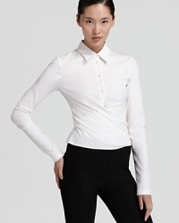 A wrap silhouette puts a new spin on this classic Donna Karan New York button-down shirt for crisp, perennial look. A wrap silhouette puts a new spin on this classic Donna Karan New York button-down shirt for crisp, perennial look.