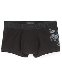 Emporio Armani updates the classic trunk with a wide, tonal waistband and skull print at the hip. Emporio Armani updates the classic trunk with a wide, tonal waistband and skull print at the hip.