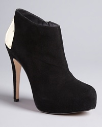 DV Dolce Vita gives these wear-everywhere booties the Midas touch with bold gold heel plates: Shine with every step. DV Dolce Vita gives these wear-everywhere booties the Midas touch with bold gold heel plates: Shine with every step.