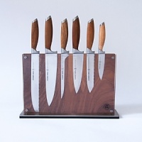German stainless steel harmonizes with Asian teak wood on this superior set of knives from Schmidt Brothers for an aesthetically pleasing and exceptionally precise collection. This set includes a 6 Double Edge Utility Knife, 8 Chef Knife, 7 Boning Knife, 6 Petite Chef Knife, 4 Paring Knife, 9 Bread Knife and Downtown Block. German stainless steel harmonizes with Asian teak wood on this superior set of knives from Schmidt Brothers for an aesthetically pleasing and exceptionally precise collection. This set includes a 6 Double Edge Utility Knife, 8 Chef Knife, 7 Boning Knife, 6 Petite Chef Knife, 4 Paring Knife, 9 Bread Knife and Downtown Block.