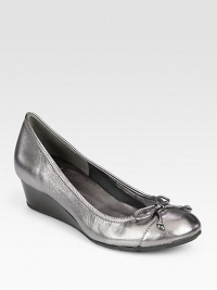 Classic style meets practicality in this sophisticated design of shimmering metallic leather with a manageable wedge. Rubber wedge, 1½ (40mm)Metallic leather upperLeather liningRubber solePadded insoleImported Classic style meets practicality in this sophisticated design of shimmering metallic leather with a manageable wedge. Rubber wedge, 1½ (40mm)Metallic leather upperLeather liningRubber solePadded insoleImported